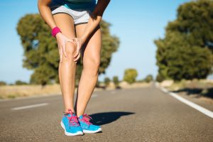 Female runner knee injury and pain.